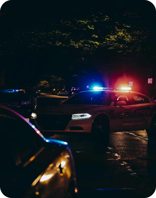 Police car lights on a wet street, OSINT support for law enforcement