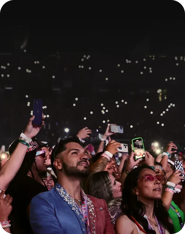 Festival crowd filming a concert stage during live event threat monitoring